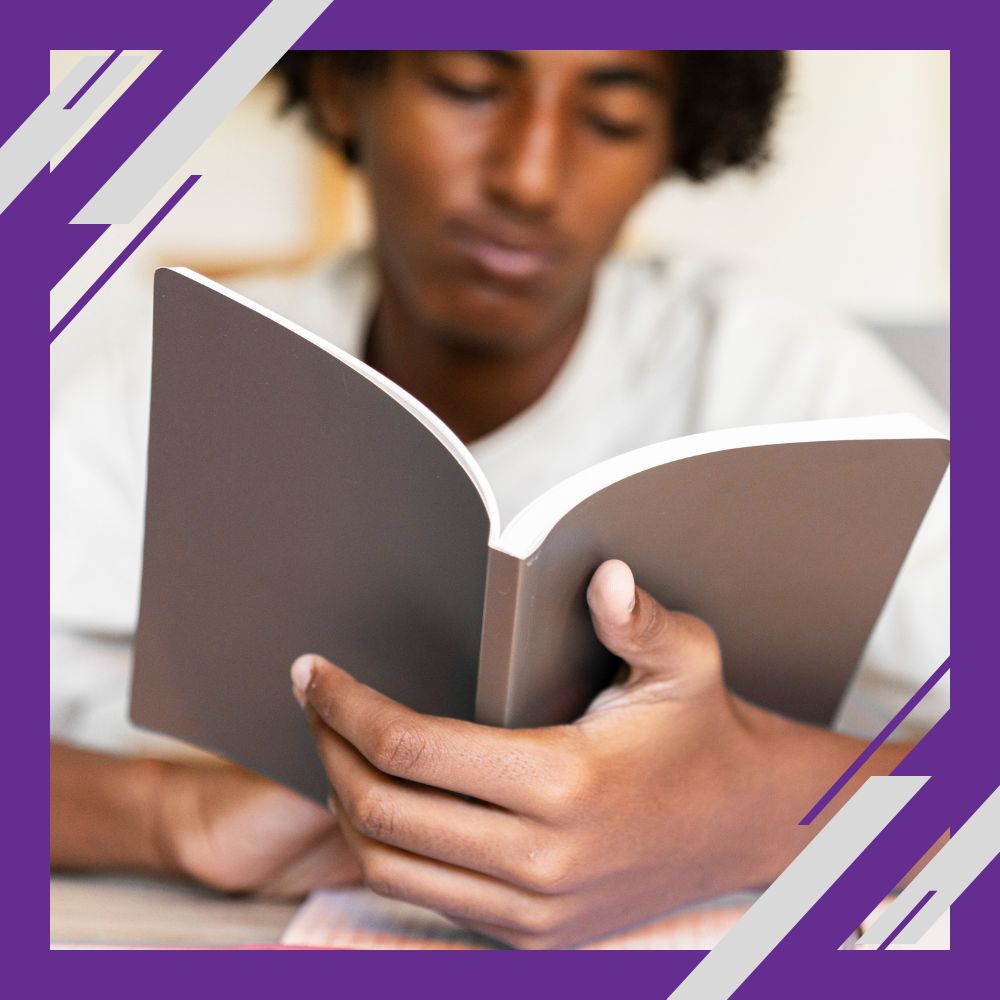 Person reading a book, with a purple geometric border framing the image.